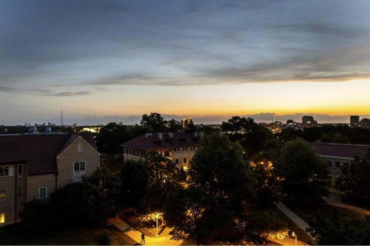 The quad on campus at sunset with the city in the background